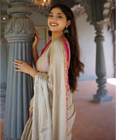 Classy Gold and Pink Saree with Glossy Finish and Tassel Accents