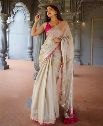 Classy Gold and Pink Saree with Glossy Finish and Tassel Accents