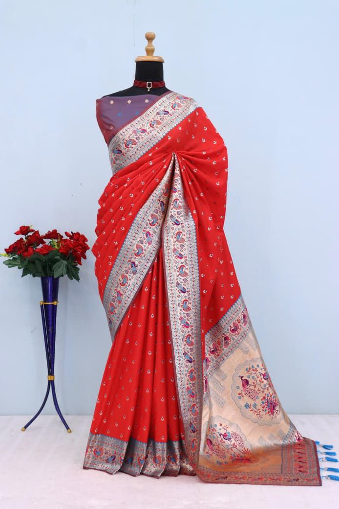 Has floral and peacock motifs on the zari border and pallu RED