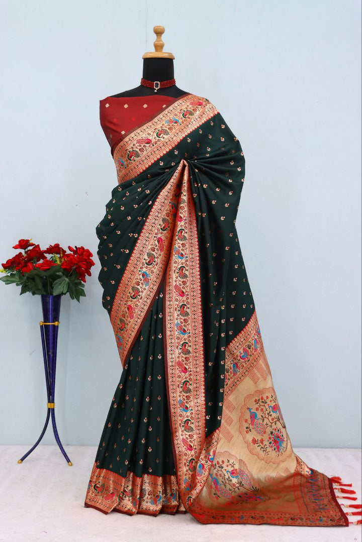 Has floral and peacock motifs on the zari border and pallu DARK GREEN