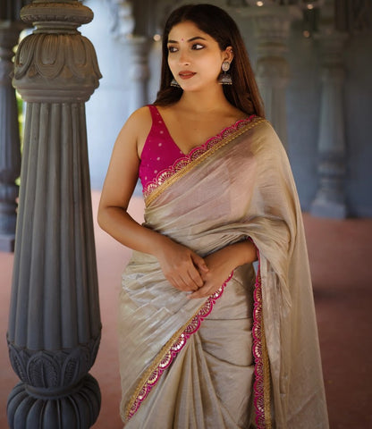 Classy Gold and Pink Saree with Glossy Finish and Tassel Accents